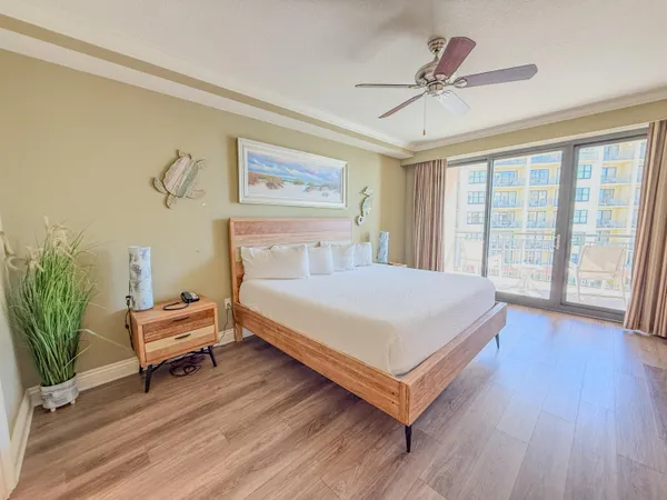 a bedroom with a bed and a potted plant