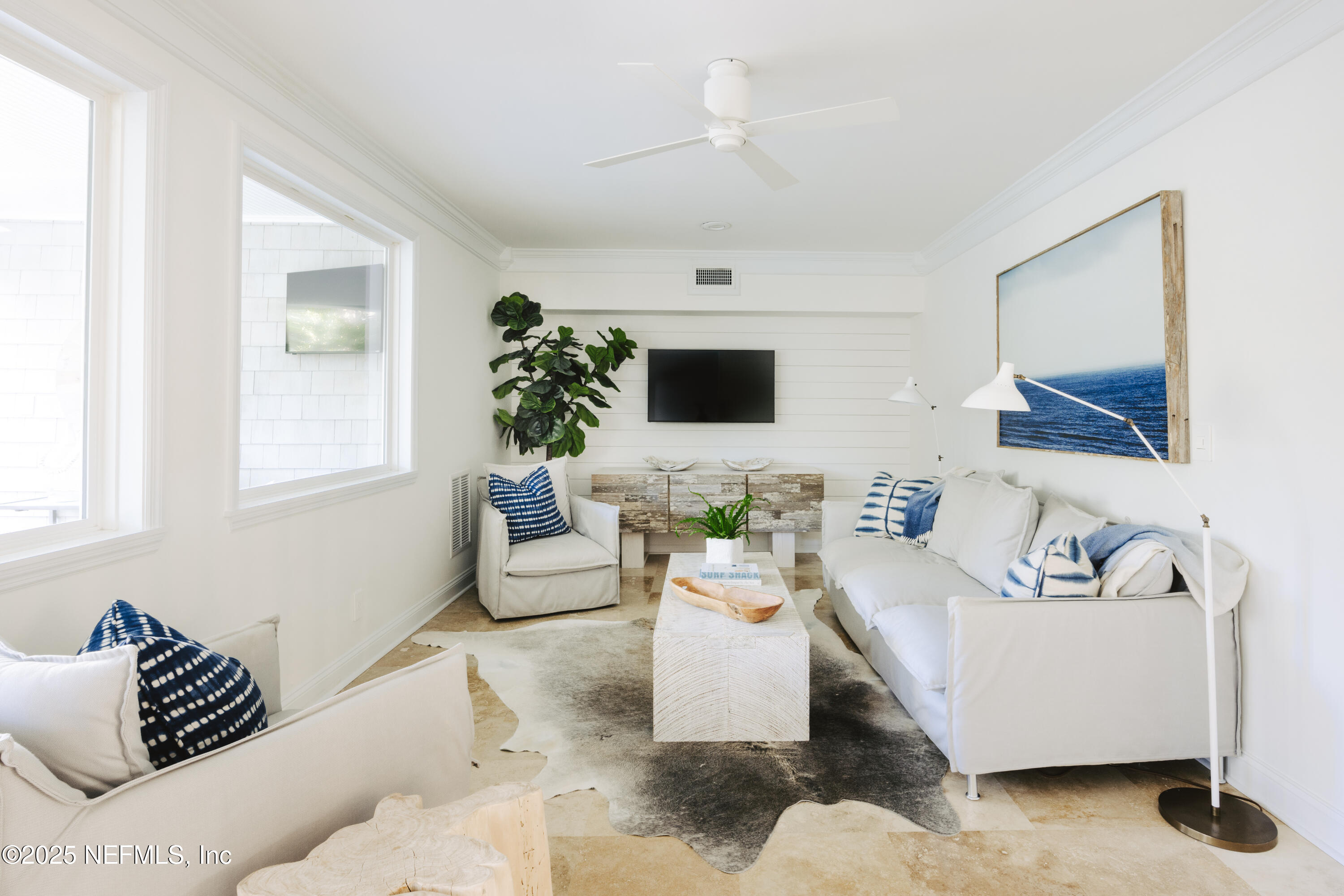 440 Ocean Boulevard Atlantic Beach, FL 32233 - Photo 12 of 34 a living room with furniture and a flat screen tv