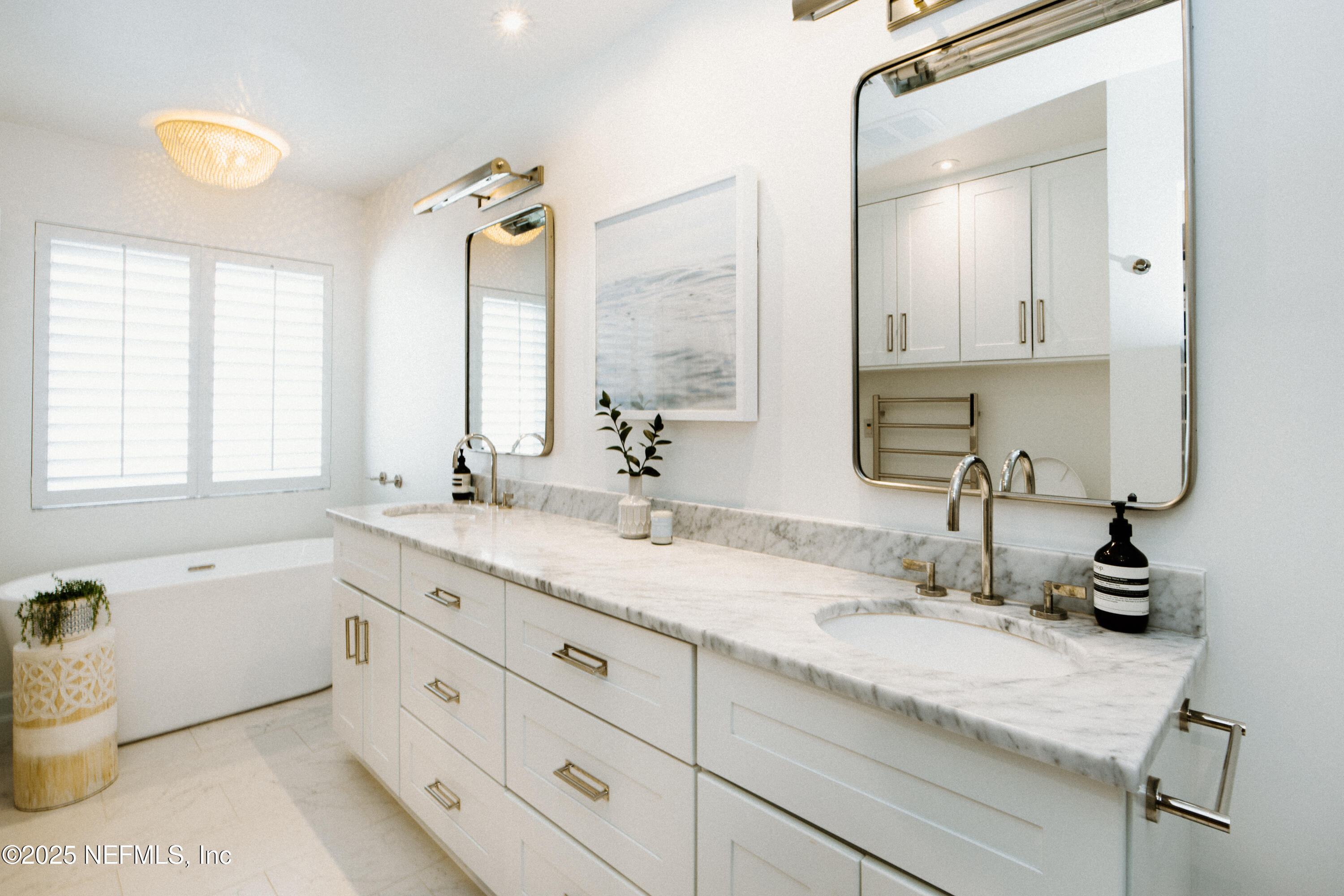 440 Ocean Boulevard Atlantic Beach, FL 32233 - Photo 18 of 34 a bathroom with a granite countertop sink mirror and a bathtub