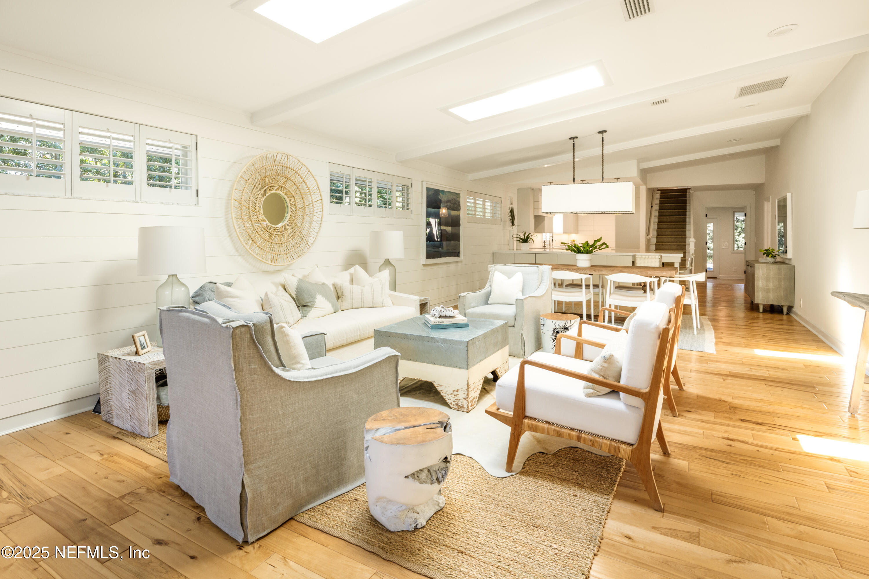 440 Ocean Boulevard Atlantic Beach, FL 32233 - Photo 2 of 34 a living room with a couch and a dining table