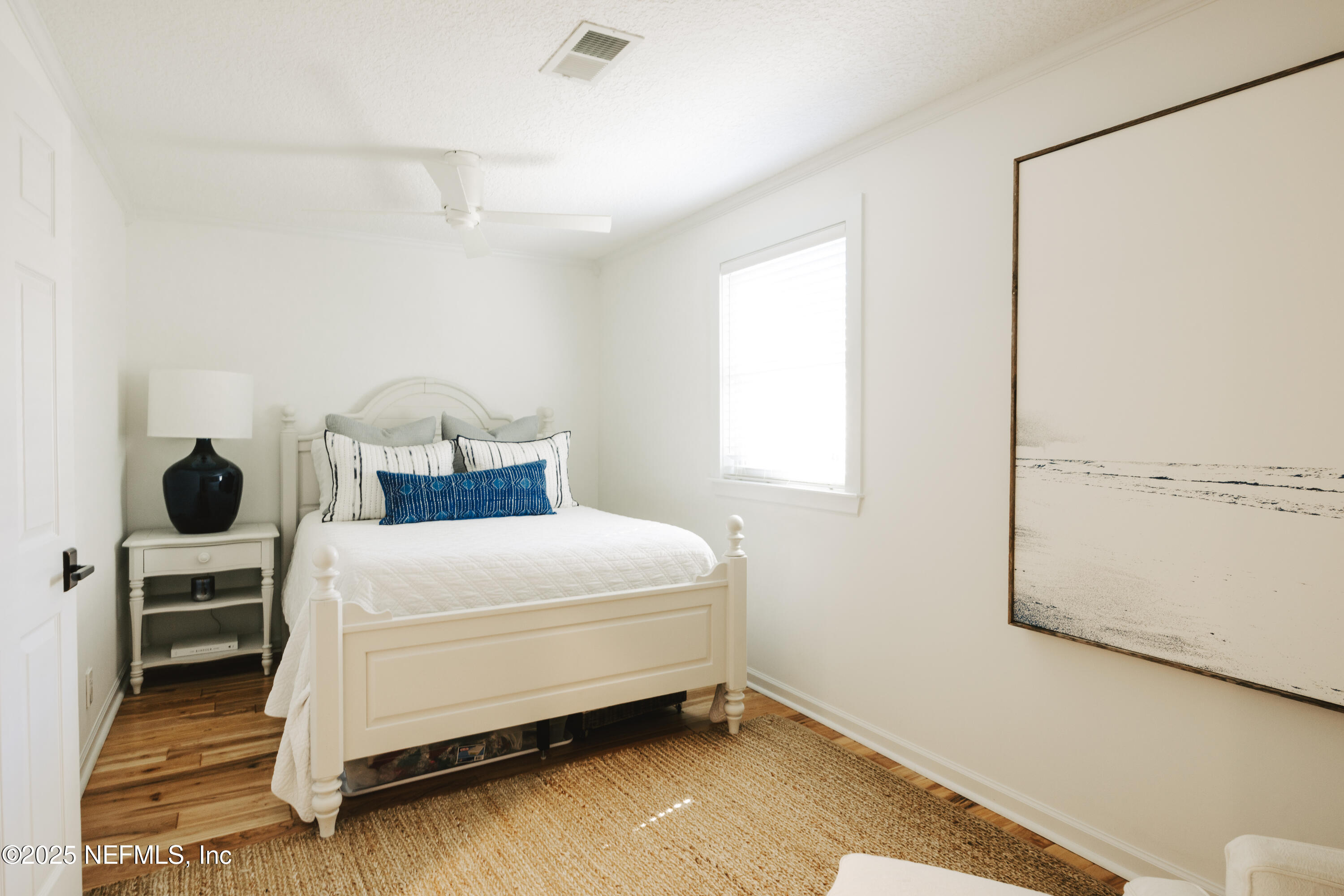 440 Ocean Boulevard Atlantic Beach, FL 32233 - Photo 21 of 34 a bedroom with a bed and a window