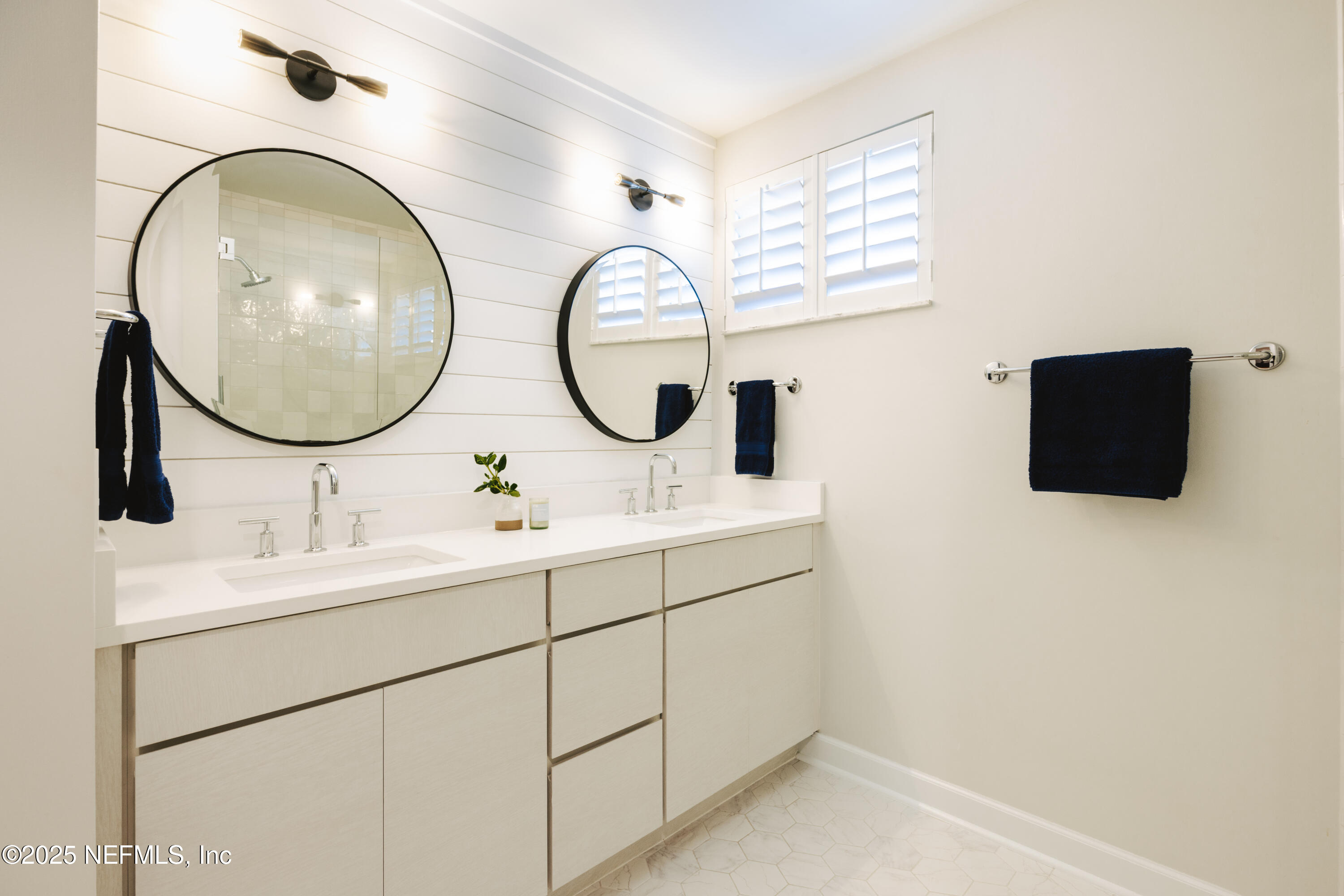 440 Ocean Boulevard Atlantic Beach, FL 32233 - Photo 22 of 34 a bathroom with a sink and a mirror