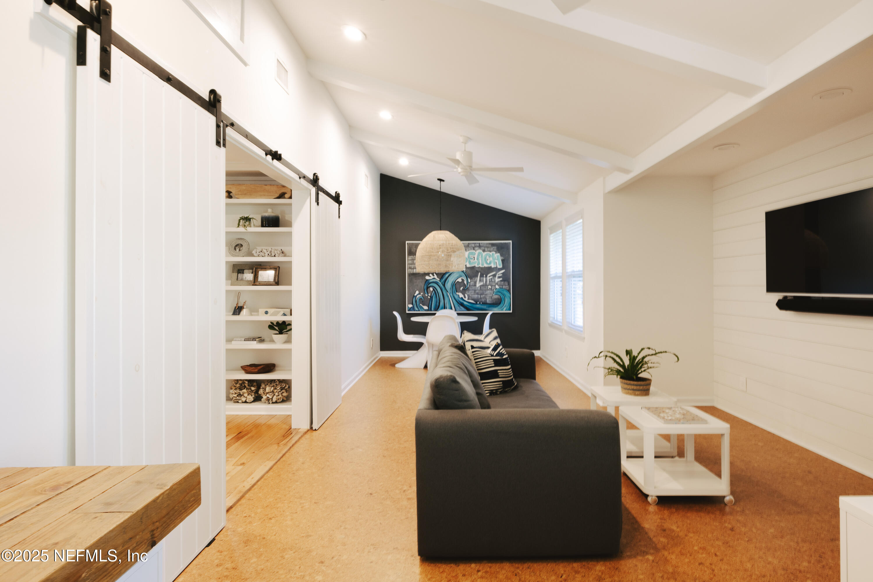 440 Ocean Boulevard Atlantic Beach, FL 32233 - Photo 24 of 34 a living room with furniture and a flat screen tv