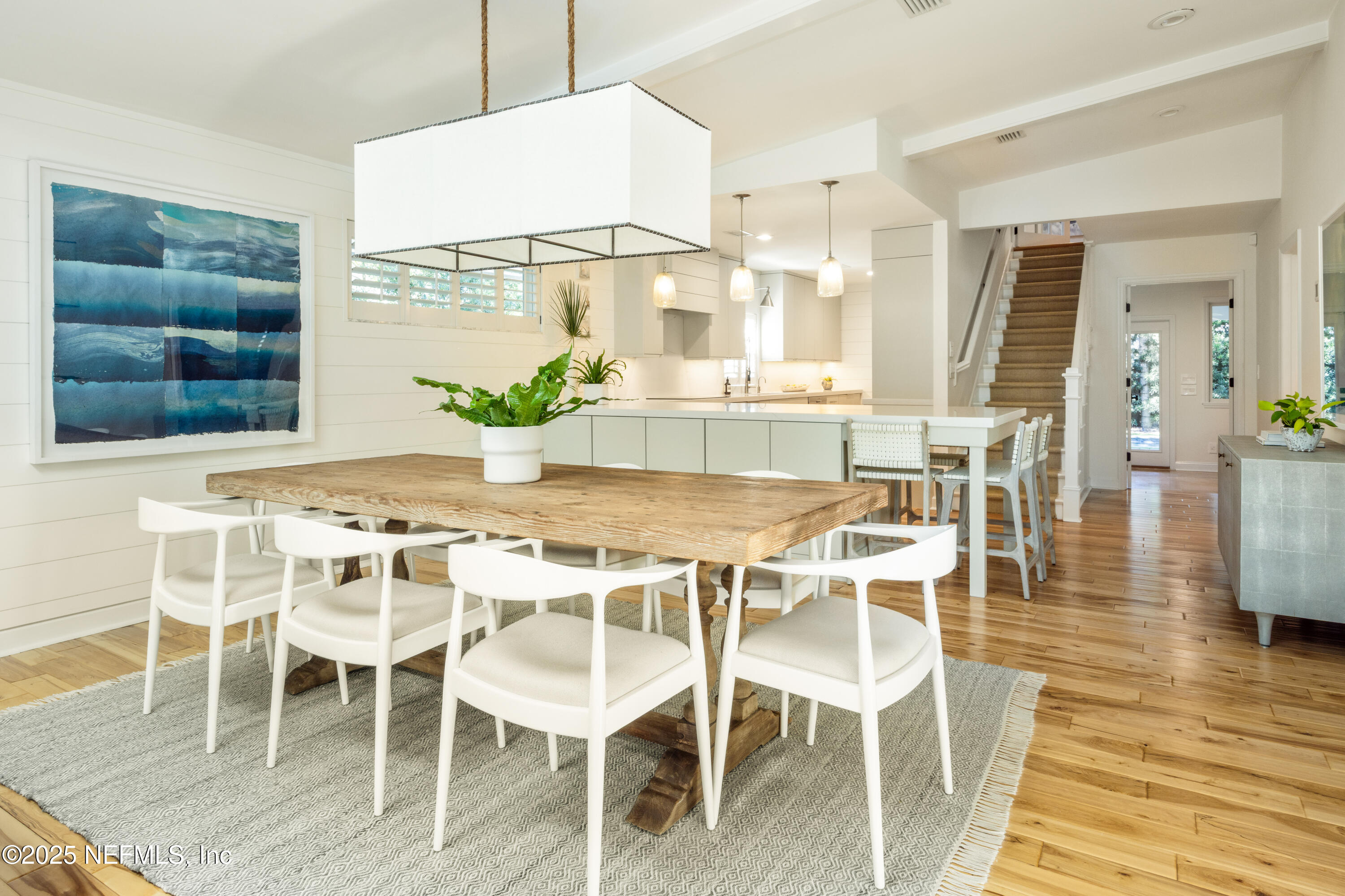 440 Ocean Boulevard Atlantic Beach, FL 32233 - Photo 5 of 34 a dining room with furniture a potted plant and wooden floor