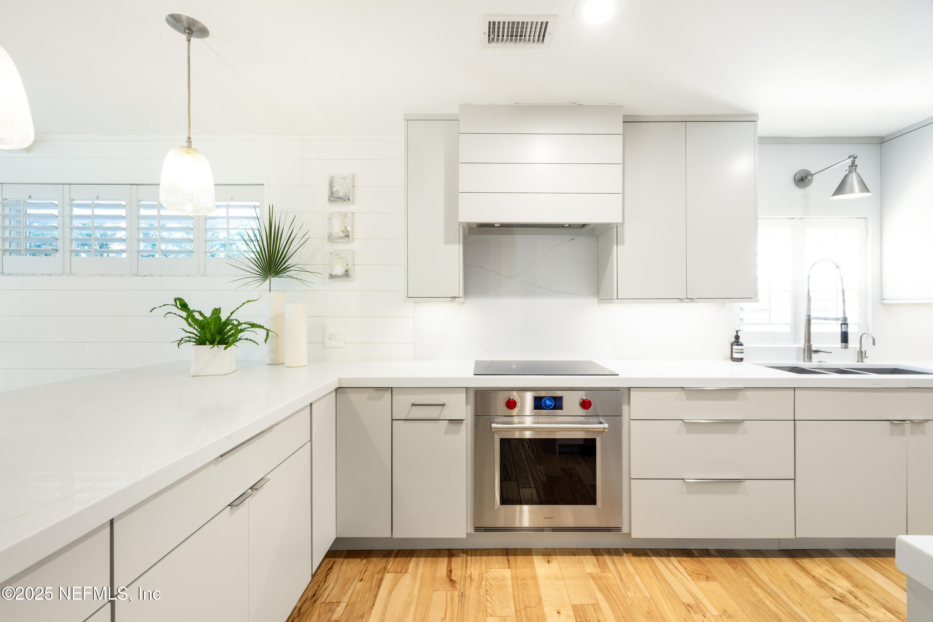 440 Ocean Boulevard Atlantic Beach, FL 32233 - Photo 9 of 34 a kitchen with stainless steel appliances white cabinets and a stove