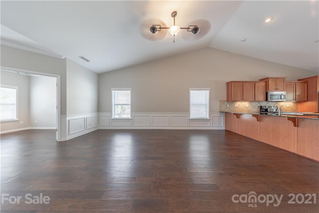 8026 Bryson Road Indian Land, SC 29707 - Photo 13 of 33 a view of kitchen with furniture and wooden floor