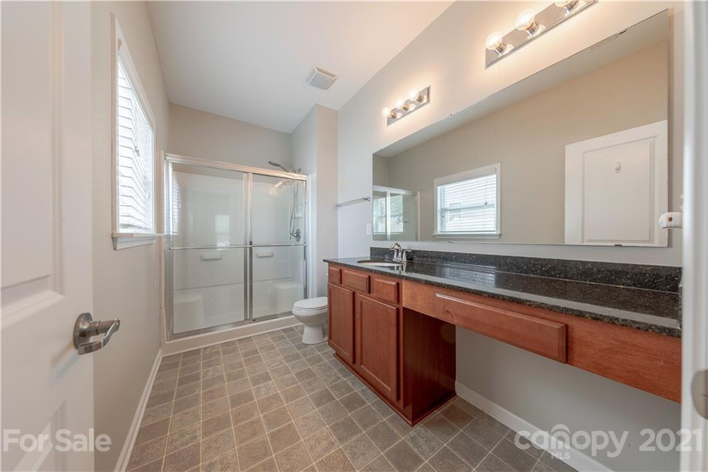 8026 Bryson Road Indian Land, SC 29707 - Photo 25 of 33 a spacious bathroom with a granite countertop sink mirror and double