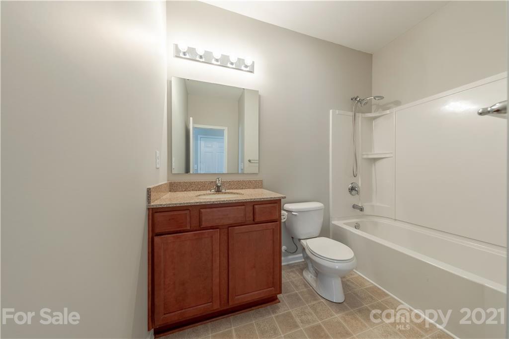 8026 Bryson Road Indian Land, SC 29707 - Photo 28 of 33 a bathroom with a sink a toilet and shower