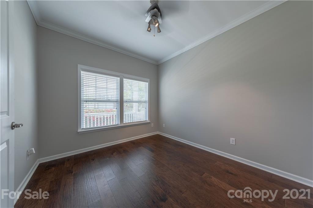 8026 Bryson Road Indian Land, SC 29707 - Photo 10 of 33 a view of an empty room with wooden floor and a window