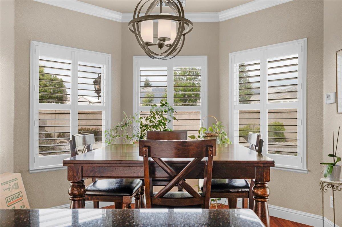 2881 Indianapolis Avenue Clovis, CA 93611 - Photo 19 of 76 a dining room with furniture a potted plant and a chandelier
