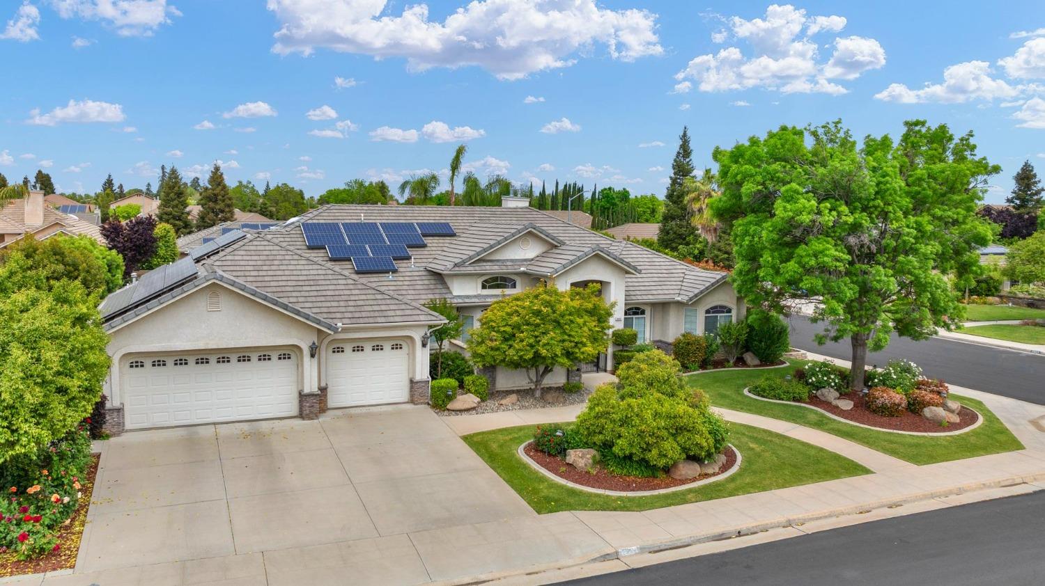 2881 Indianapolis Avenue Clovis, CA 93611 - Photo 2 of 76 a view of a house with a yard and potted plants