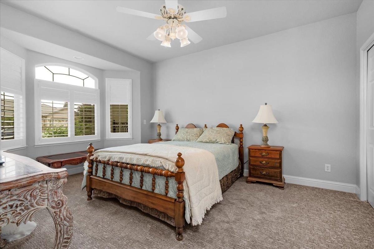 2881 Indianapolis Avenue Clovis, CA 93611 - Photo 39 of 76 a bedroom with a bed lamp and a window