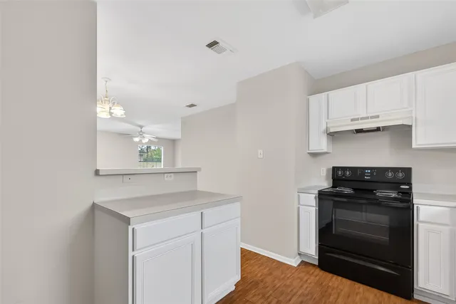 a kitchen with a sink stove and refrigerator