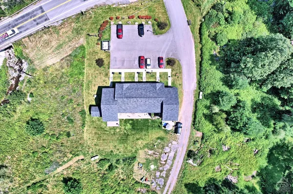 an aerial view of a house with a yard