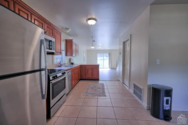 a view of a kitchen with wooden floor and stairs