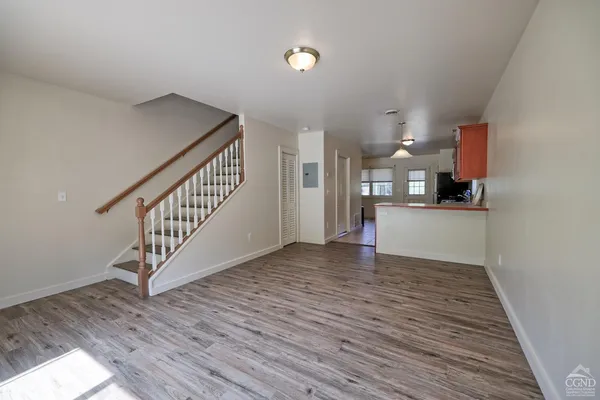 an empty room with wooden floor and white walls