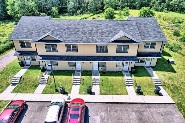 an aerial view of a house with a yard and garden