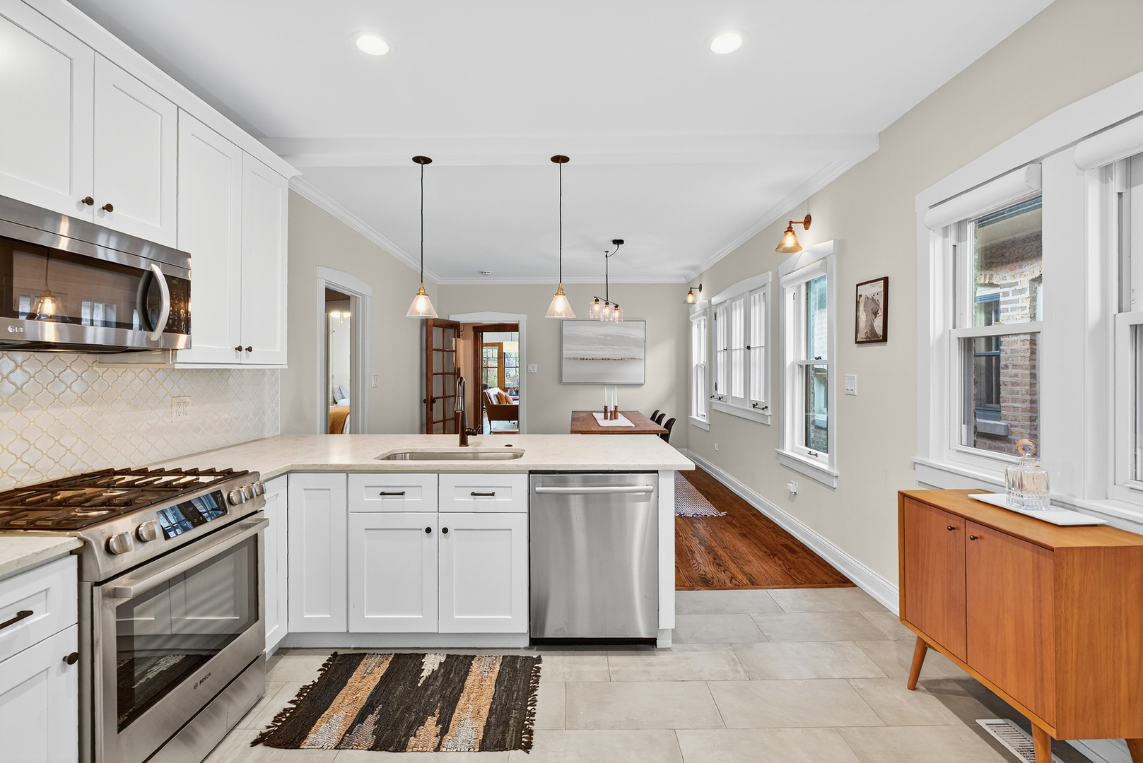 4431 North Richmond Street Chicago, IL 60625 - Photo 12 of 36 a kitchen with stainless steel appliances a stove a sink and a microwave