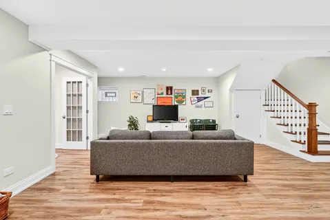 a living room with furniture and a wooden floor