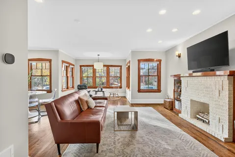 a living room with furniture a flat screen tv and a fireplace