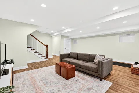 a living room with furniture and stairs