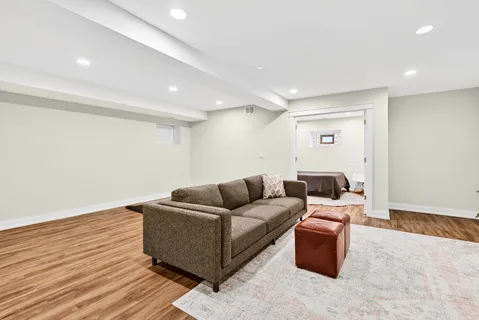 a living room with furniture and a wooden floor