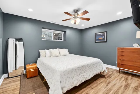 a bedroom with a bed and a chandelier