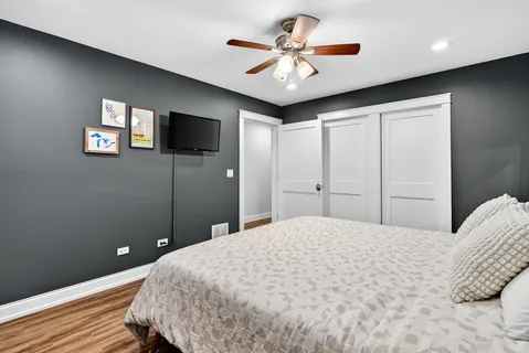 a bedroom with a large bed and a flat screen tv