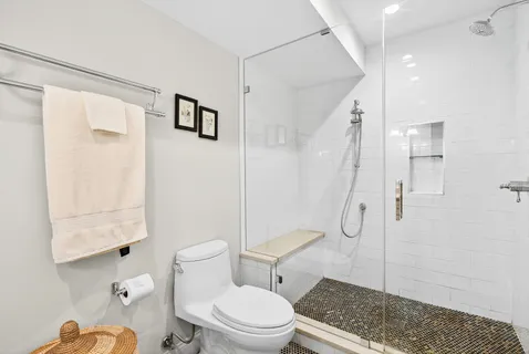 a white toilet sitting next to a bathroom sink