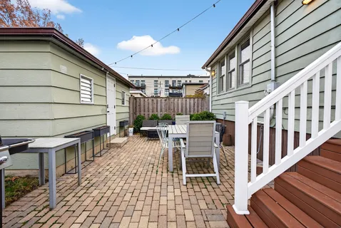 a view of a chairs and table in the balcony