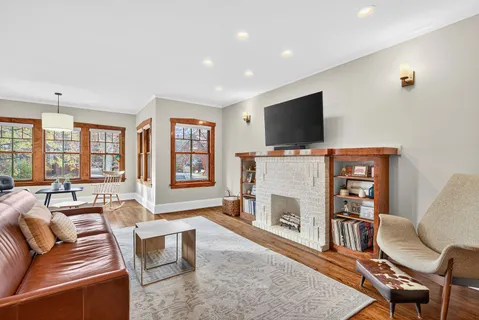 a living room with furniture a flat screen tv and a fireplace