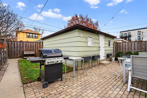 a view of a chairs and table in backyard