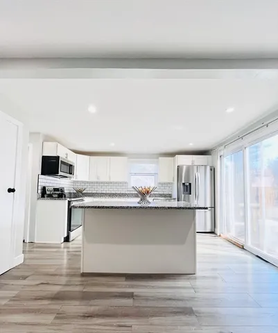 a kitchen with stainless steel appliances a sink and cabinets