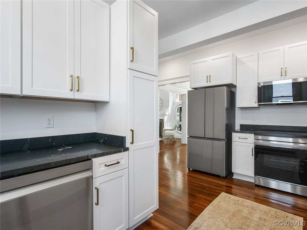 109 Overbrook Road Richmond, VA 23222 - Photo 18 of 47 a kitchen with a refrigerator stove and white cabinets