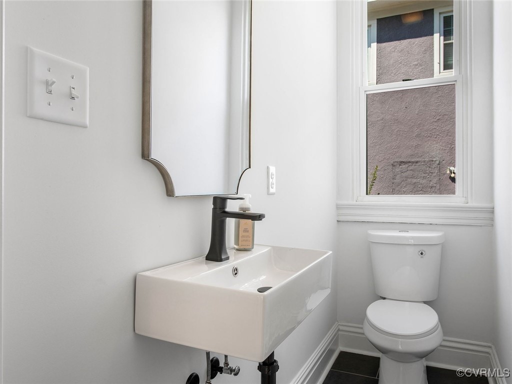 109 Overbrook Road Richmond, VA 23222 - Photo 19 of 47 a bathroom with a toilet sink and mirror