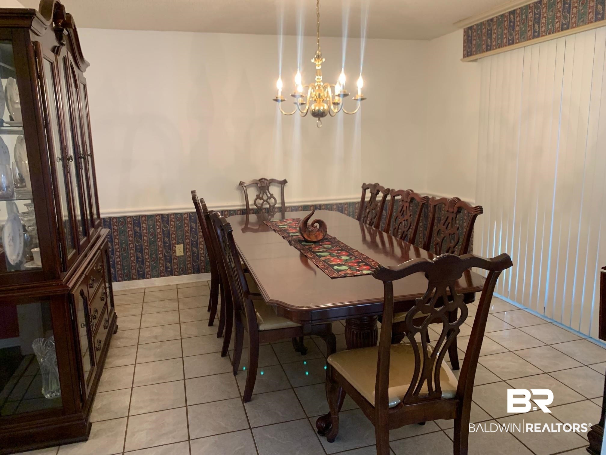 133 Dunbar Loop Daphne, AL 36526 - Photo 9 of 15 Dining area with a chandelier and light tile patterned floors