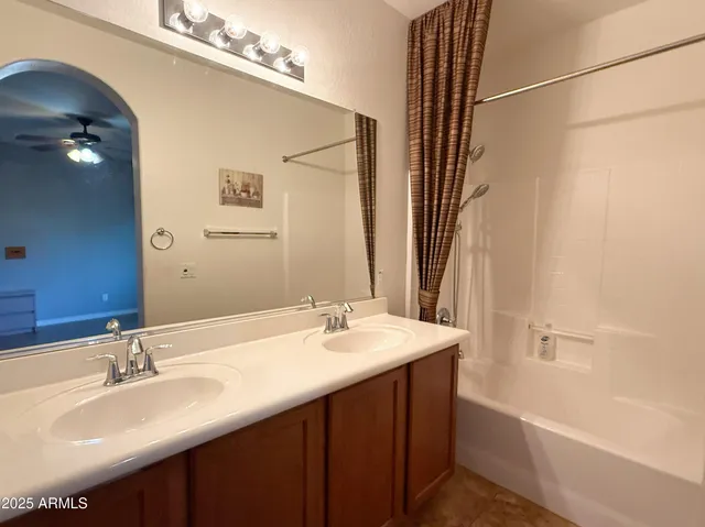 a bathroom with a double vanity sink and a mirror