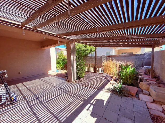 a view of a backyard with wooden fence