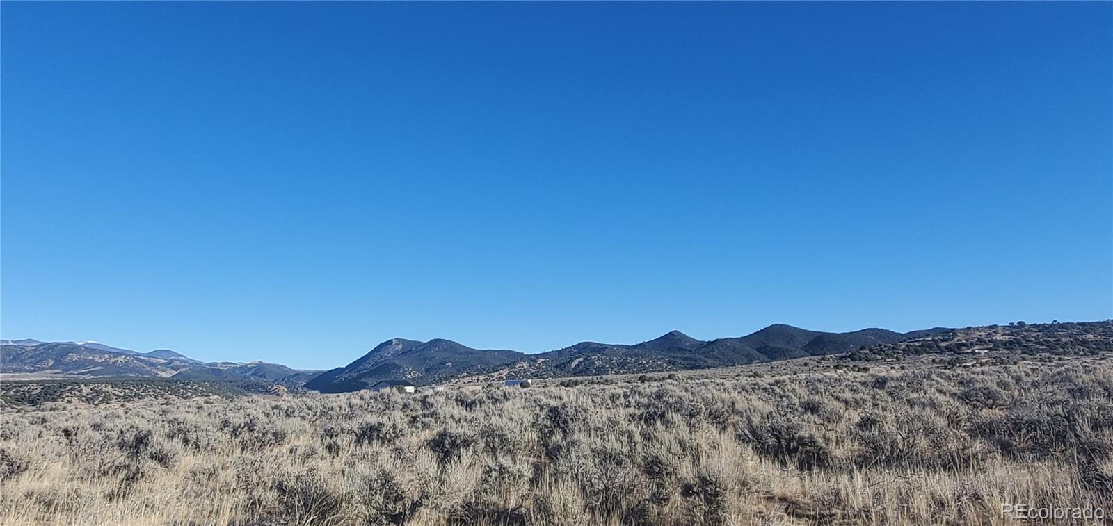 Lot 4125 Woodman Road Fort Garland, CO 81133 - Photo 3 of 14 a view of a town with mountains in the background