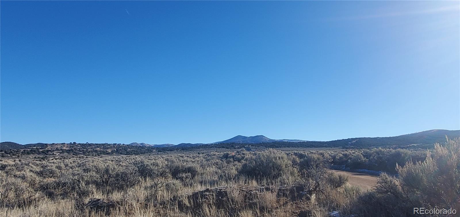 Lot 4125 Woodman Road Fort Garland, CO 81133 - Photo 4 of 14 a view of a mountain range with a lush green hillside