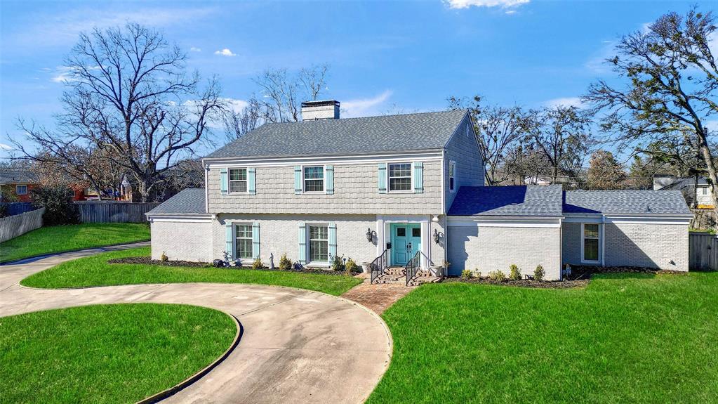 a front view of house with yard and green space