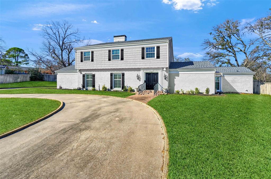 1016 Crestview Drive Sherman, TX 75092 - Photo 2 of 13 a view of a white house with a big yard and large trees