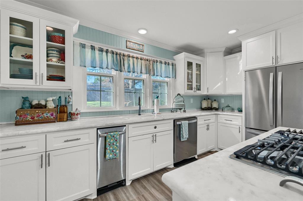 1016 Crestview Drive Sherman, TX 75092 - Photo 5 of 13 a kitchen with white cabinets and white appliances