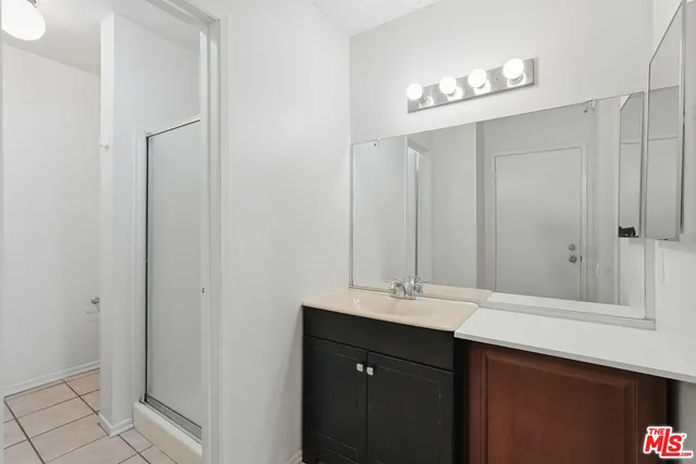 a bathroom with a double vanity sink and a mirror