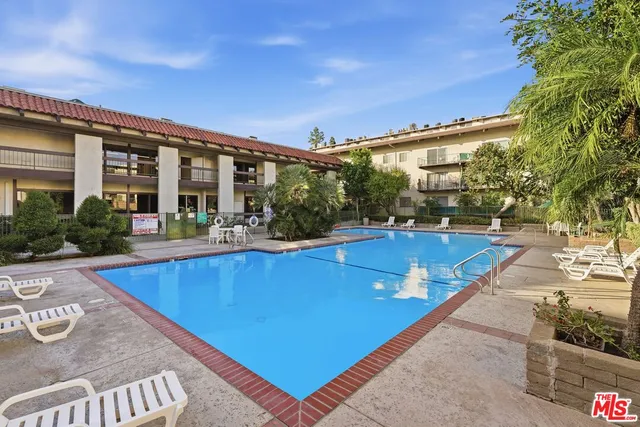 a view of a patio with a table and chairs