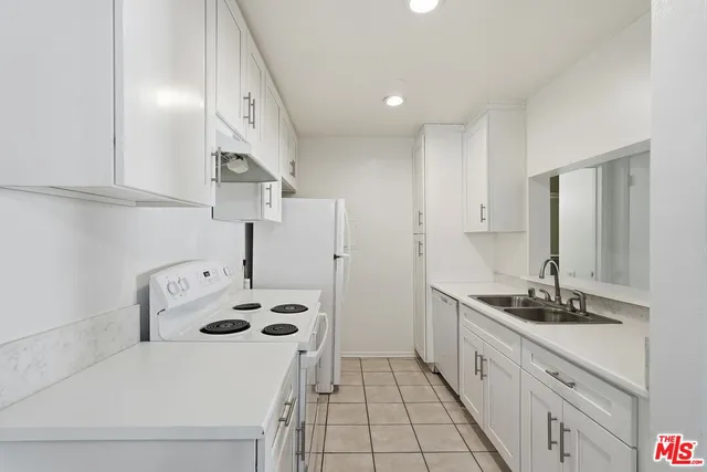 a kitchen with sink a stove and refrigerator