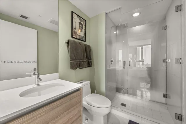 a bathroom with a sink toilet and shower