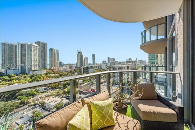 a view of a balcony with wooden chairs