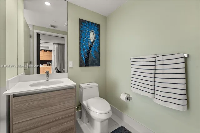 a bathroom with a sink a toilet and mirror