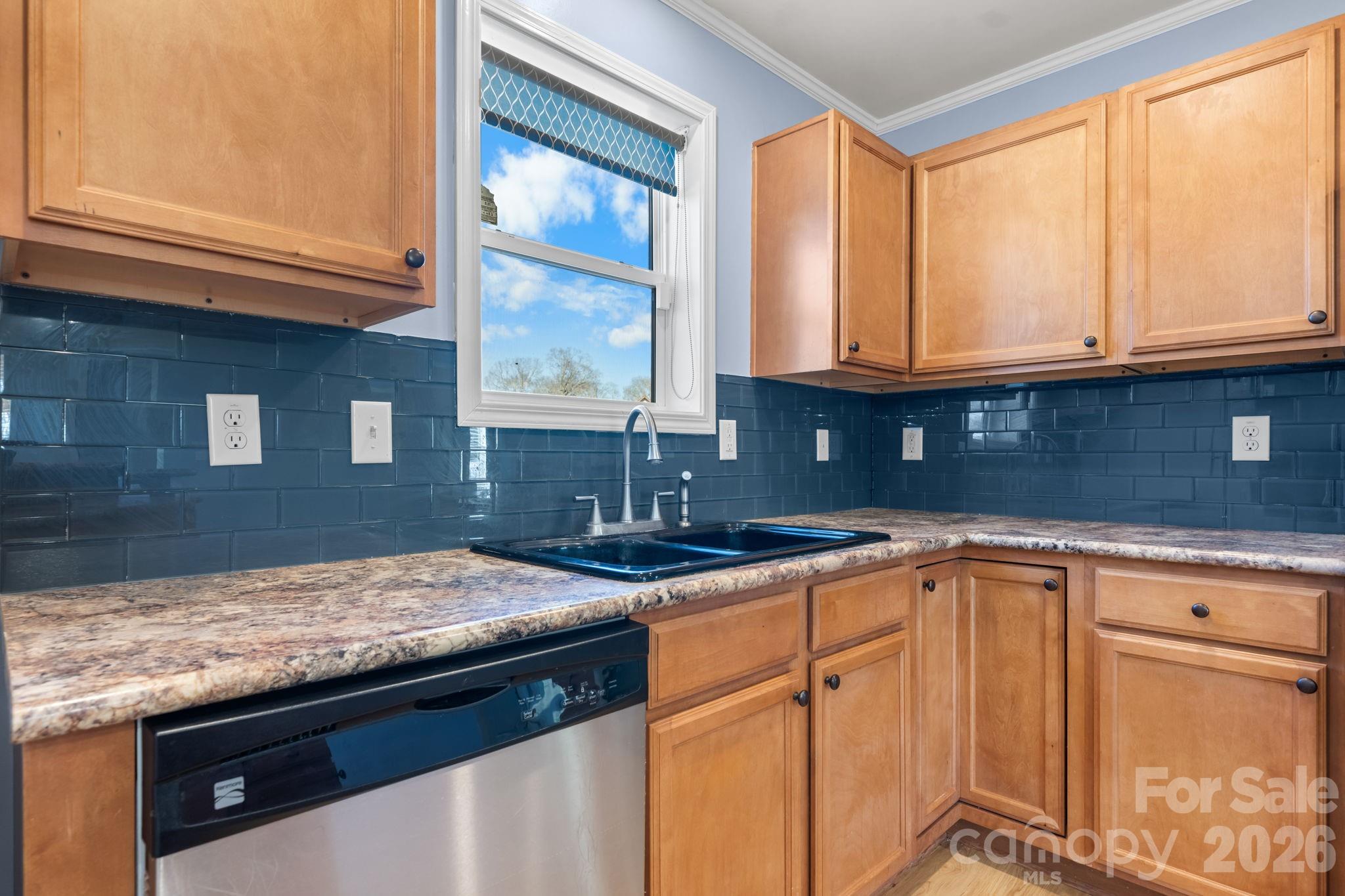 999 Stone Throw Drive Concord, NC 28025 - Photo 4 of 23 a kitchen with granite countertop a sink and a stove